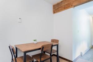 a wooden table and chairs in a room at Manitou Lodge 4 by Alpine Lodging Telluride in Telluride