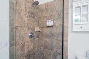 a bathroom with a shower with a glass door at Manitou Lodge 6 by Alpine Lodging Telluride in Telluride