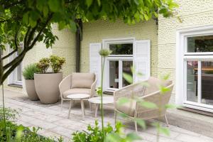 two chairs and a table on a patio at Villa Rein Boutiquehotel in Bad Reichenhall
