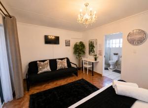 a living room with a couch and a table at Zhantique Guest House 1- Unit 5 in Boksburg