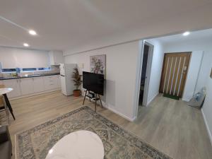 a living room with a television and a kitchen at Private Coastal Sanctuary Beachside Escape in Bunbury