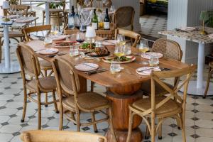 a wooden table with plates of food and glasses of wine at Tintswalo Summer House in Glencairn