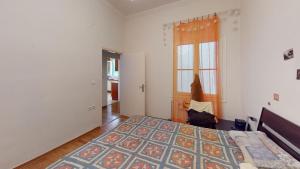 a bedroom with a large bed and a window at Amimoni Apartment in Nafplio