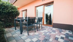 a black table and chairs on a patio at BlueBird Apartments in Latschach +12 photos