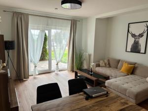 a living room with a couch and a table at BlueBird Apartments in Latschach