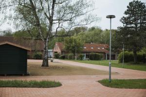 a street light next to a house with a tree at Pension Altes Schulhaus in Leuna