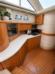 a kitchen in a boat with wooden cabinets at Midnight business in Thorpe