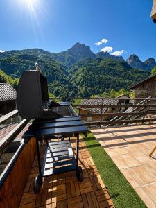a laptop on a table on a balcony with mountains at Casa DiMont Sauna & Relax in Salino