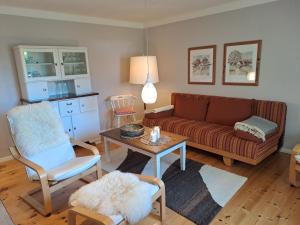a living room with a couch and a table at Ferienwohnung Rahn in Freienwill +21 photos