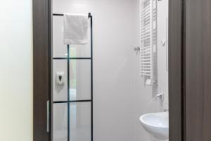 a bathroom with a glass shower door next to a sink at Bardo CAMP in Bardo