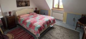a bedroom with a bed with a colorful comforter at Penn Ar Bed & Breakfast in Plozévet