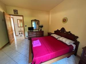 a bedroom with a large bed with a red blanket at Avventura e Relax a Bagnasco 1 in Bagnasco