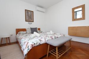a bedroom with a bed and a mirror on the wall at Rooms and Studio Salvi in Rovinj +31 photos