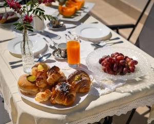 a table with two plates of pastries and fruit at Monnalisa Rooms in San Vito lo Capo