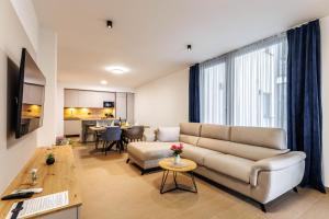 a living room with a couch and a table at Stella Maris Deluxe in Podstrana