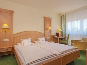 En eller flere senger på et rom på Hotel Heidelberg