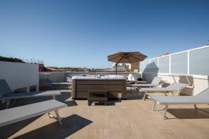 a patio with chairs and a piano on a roof at Monnalisa Rooms in San Vito lo Capo