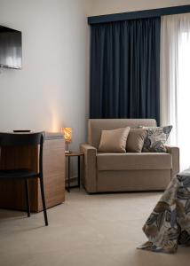a living room with a couch and a table at Monnalisa Rooms in San Vito lo Capo