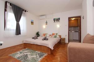 a bedroom with a bed with two teddy bears on it at Rooms and Studio Salvi in Rovinj