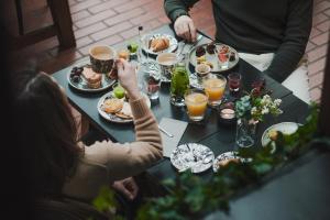 a group of people sitting at a table with food at Arctic Light Hotel in Rovaniemi