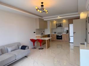 a living room with a couch and a table at Dalaman Airport Suite 11 in Dalaman +10 photos