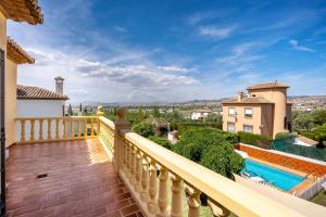 a balcony of a house with a swimming pool at Cypress House La Zubia in La Zubia