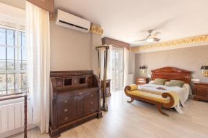 a bedroom with a bed and a dresser and a window at Cypress House La Zubia in La Zubia +19 photos