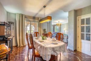 a dining room with a table and some chairs at Cypress House La Zubia in La Zubia