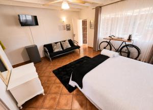 a bedroom with a bed and a couch in a room at Zhantique Guest House 1- Unit 4 in Boksburg