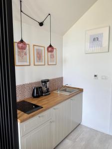a kitchen with a counter top and a sink at ODSKOCZNIA Rewa in Rewa +25 photos