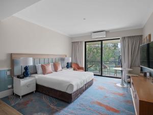 a hotel room with a bed and a balcony at The Sebel Busselton in Busselton +133 photos