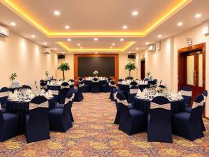 a banquet hall with tables and chairs in a room at Oscar Saigon Hotel in Ho Chi Minh City