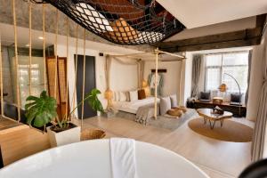 a bedroom with a bed and a living room at YOLO Bangkok Boutique Hotel in Bangkok +80 photos