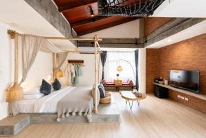 a bedroom with a canopy bed and a television at YOLO Bangkok Boutique Hotel in Bangkok