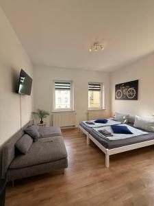 a large bedroom with a bed and a couch at Stay&Work Döbeln - Hermsdorfer Straße in Döbeln