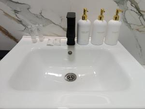 a white sink with three bottles on top of it at ЖК Akjol in Astana