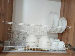 a shelf in a refrigerator filled with white dishes at ЖК Akjol in Astana
