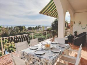 a table and chairs on the balcony of a house at Casita Bouganvilla in Roses