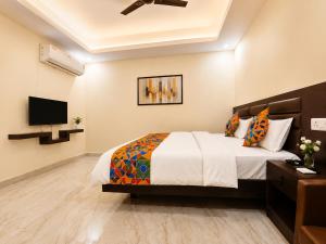 a bedroom with a bed and a flat screen tv at Guest House RK inn in Gorakhpur