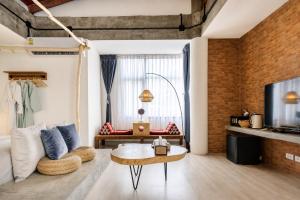 a living room with a couch and a table at YOLO Bangkok Boutique Hotel in Bangkok