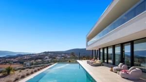 a villa with a swimming pool and a house at Villa Sun dance by Villas Guide in Vrbnik