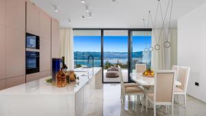 a kitchen with a table and chairs and a dining room at Villa Sun dance by Villas Guide in Vrbnik