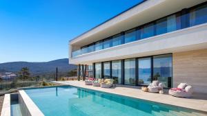 a house with a swimming pool with a view at Villa Sun dance by Villas Guide in Vrbnik