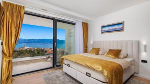a bedroom with a bed and a large window at Villa Sun dance by Villas Guide in Vrbnik +39 photos