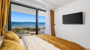 a bedroom with a bed and a large window at Villa Sun dance by Villas Guide in Vrbnik