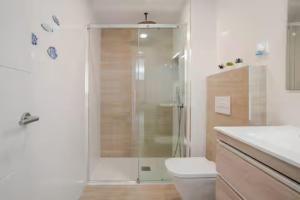a bathroom with a shower with a toilet and a sink at Ático puerto Burriana in Burriana +20 photos