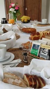 a table with bread and other food on it at L'Orée des Vignes 41 - Chambres d'hôtes in Saint-Georges-sur-Cher