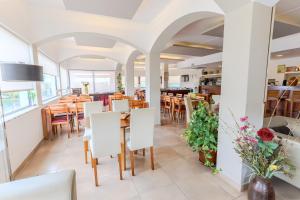 a dining room with tables and chairs in a restaurant at Casa Do Vale Hotel by Umbral in Évora