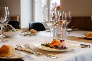 a table with plates of food and wine glasses at Schloss Freudenfels in Eschenz