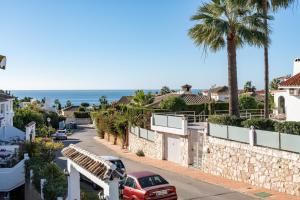 a car parked on a street next to a wall at Apartment Mijas Sun and Beach in Sitio de Calahonda